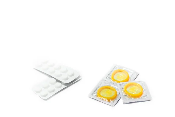 Womans hands with birth control pills and condom 스톡 사진