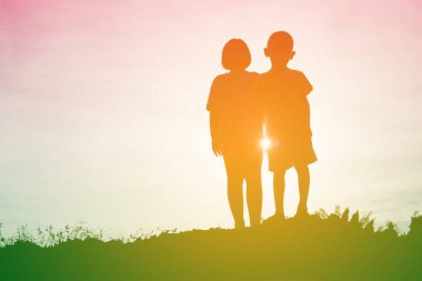 mutlu bir çocuk silüeti ve mutlu zaman günbatımı