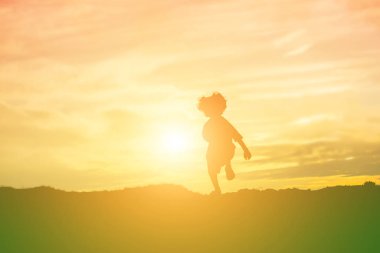 Çocuk siluet, çocuğun sevinç anlar. Doğa günbatımı