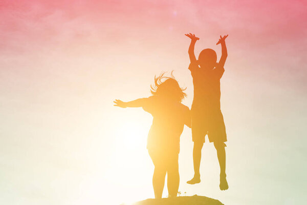 silhouette of a happy children and happy time sunset