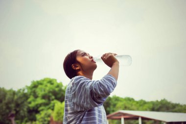 Ormandaki şişeden su içen kız
