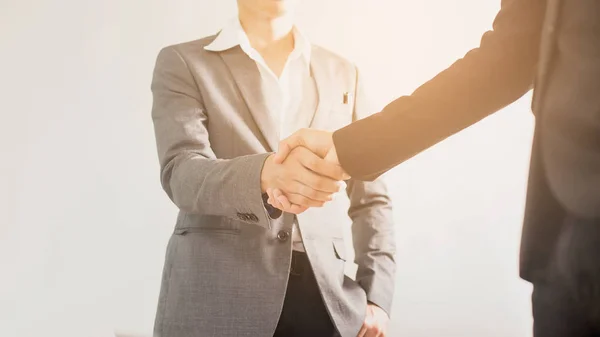 image of businessmen is shaking hands, businessman agrees to be the same cooperate in order to step through away the bad economy together.