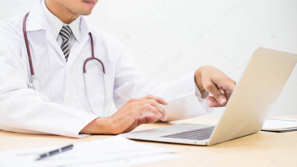 Young doctor working in his office stock photo