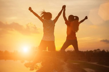 Gün batımında güçlü kendine güvenen kadın kollarını aç.. 