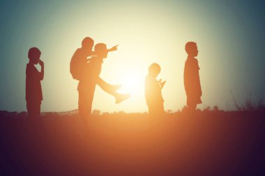 mutlu bir çocuk silüeti ve mutlu zaman günbatımı