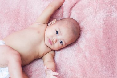 Yeni doğmuş bebek kameraya bakıyor.