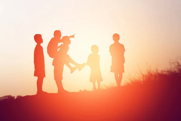 silhouette of a happy children and happy time sunset