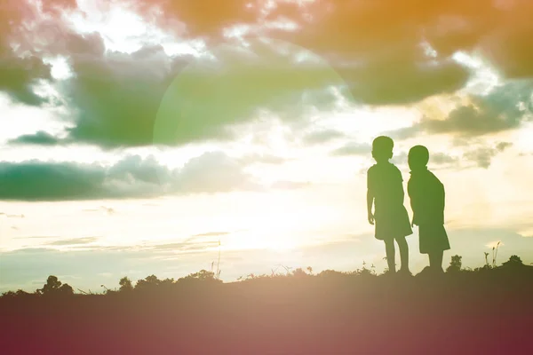 silhouette of a happy children and happy time sunset