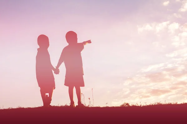 silhouette of a happy children and happy time sunset