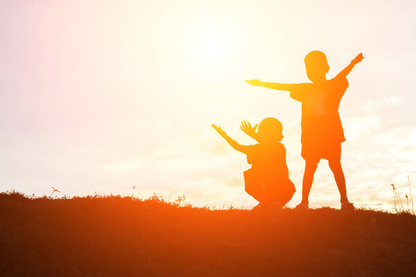 silhouette of a happy children and happy time sunset