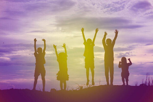 silhouette of a happy children and happy time sunset
