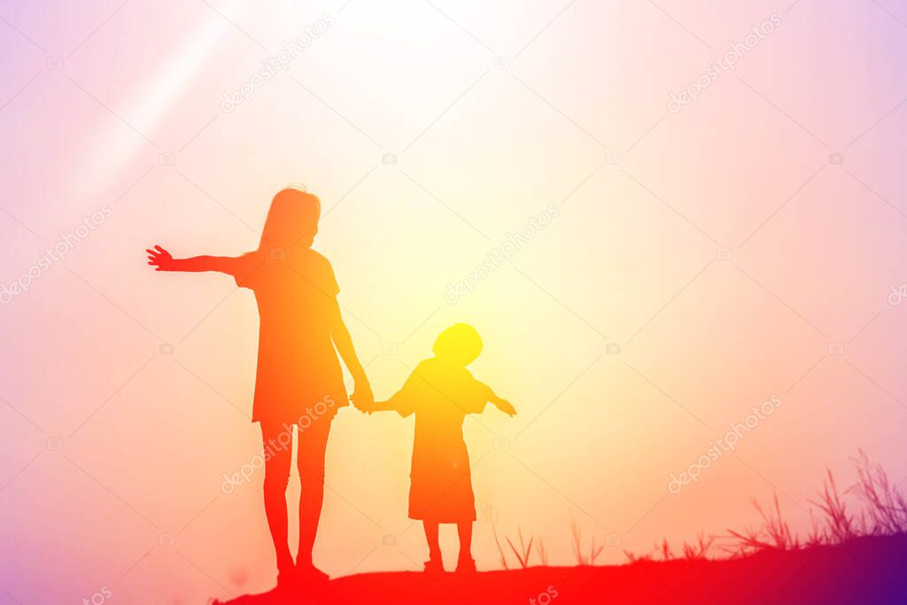 Mother encouraged her son outdoors at sunset