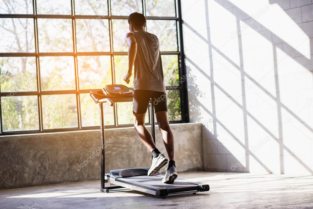 Young men exercise on an automatic treadmill