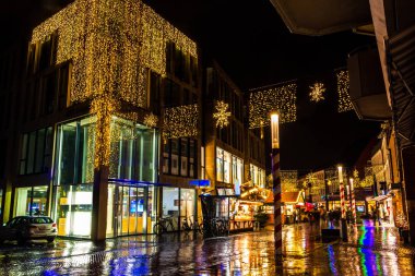 Akşamları Nordhorn kırsalındaki binalarda bir sürü sarı renkli noel ışıklarıyla Noel panayırı