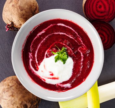 Beetroot, red borscht with sour cream and parsley clipart