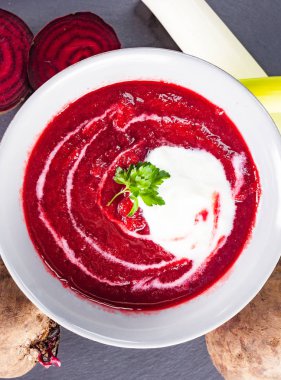 Beetroot, red borscht with sour cream and parsley. clipart