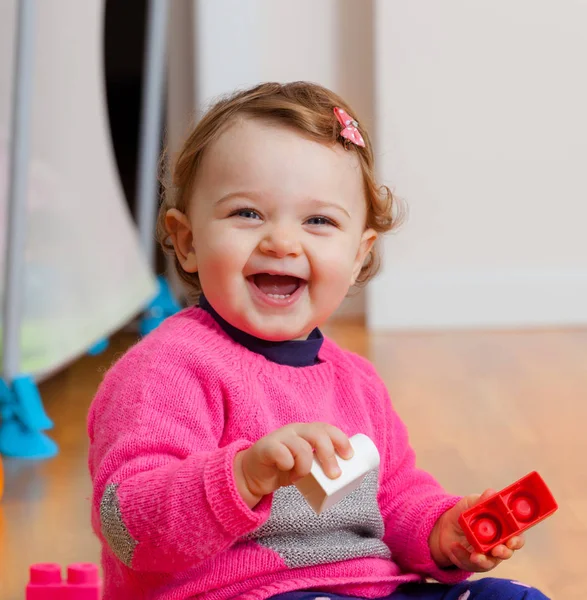 Toddler baby girl playing with rubber building blocks. — Stock Photo, Image