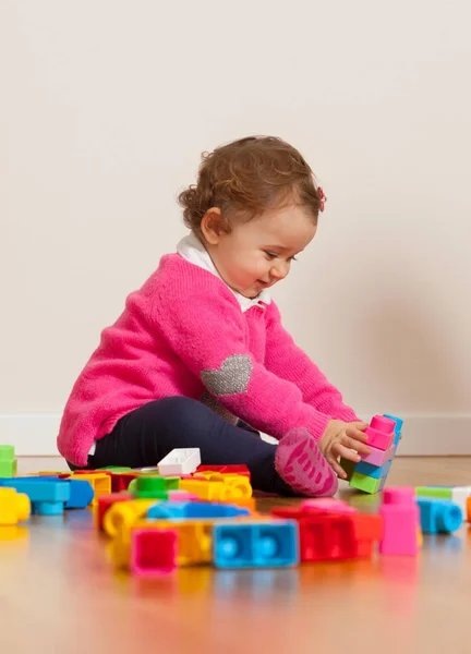 Девочка, играющая резиновыми строительными блоками . — стоковое фото