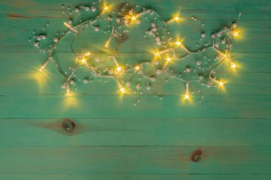 Christmas rustic background with garland lights and free text space