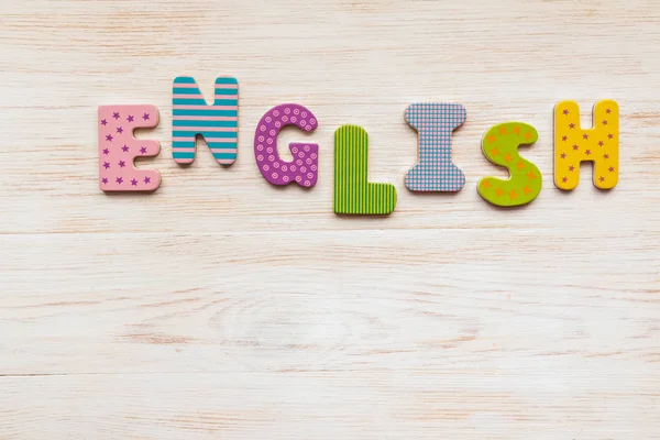 Wood letters written word English on wooden background — 스톡 사진