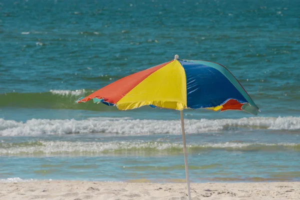 Beach umbrella sunny day on wavy sea background