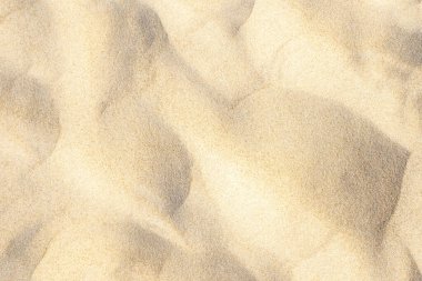 Light sand pattern on beach near sea in summer background