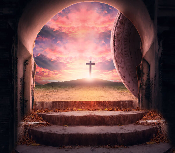 Easter Sunday concept: Tomb empty with cross on sunset background