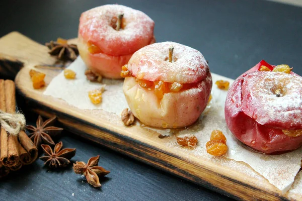 baked apple with christmas spices on wooden background