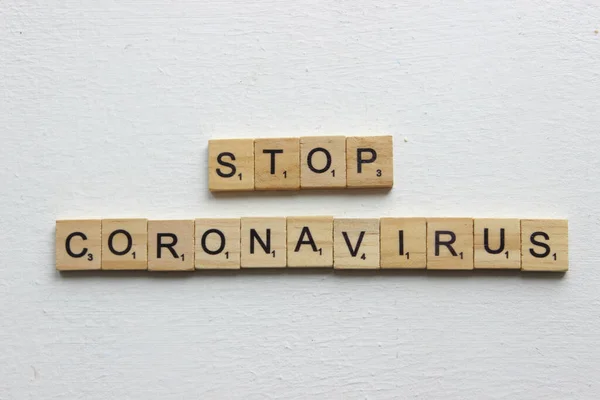 stock image top view of wooden blocks with the words stop coronavirus on a white background. Stop the global coronavirus pandemic 2019. Copy of the space.