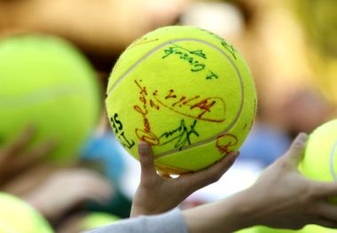 Tennis fans hold a ball asking for an autograph to the players during a Barcelona tennis tournament Conde de Godo on April 22, 2015 in Barcelona Spain clipart