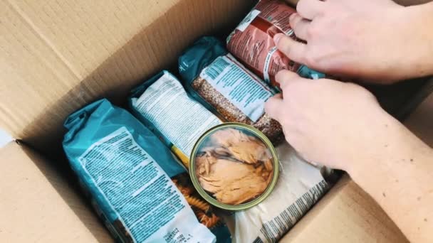 コロナウイルスのパンデミックの間の貧しい人々への慈善援助 食料品の紙パックの収集と配送 — ストック動画