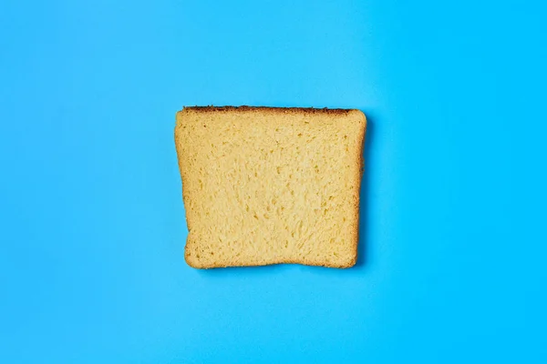 One Square Piece Yellow Vanilla Bread Toast Lies Blue Table — Stock Photo, Image