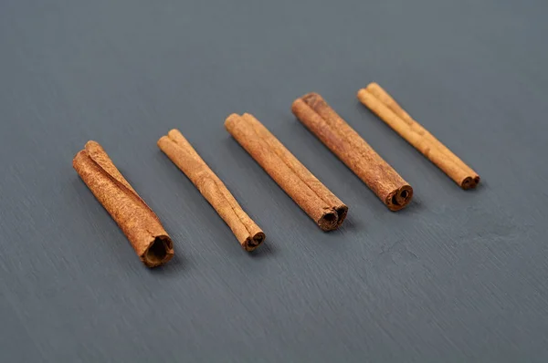 Row Five Flavour Cinnamon Stick Lies Dark Scratched Desk Kitchen — Stok Foto