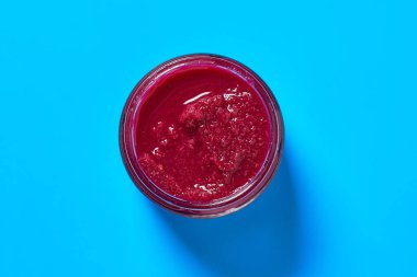 Mutfaktaki mavi masada bir kavanoz taze baharatlı yaban turpu duruyor. Üst Manzara. Yakın plan.