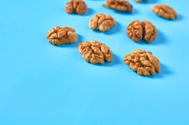 Mavi arka planda dağınık ceviz lapası. Boşluğu kopyala