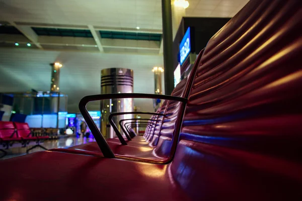 Rows of seats at the airport, close-up. Seats in the waiting room at the station, selective focus. Modern airport, futuristic design.