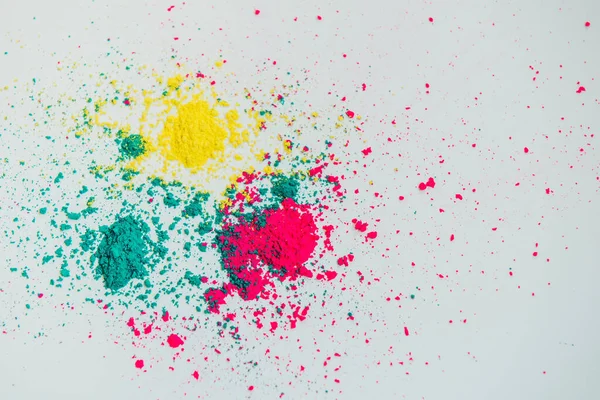 Abstract multicolor powder mixed on white background. Freeze motion of color powder. Concept Indian festival Holi.