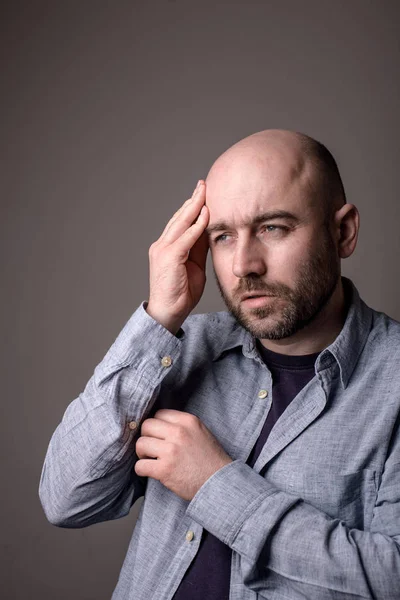 depressed sad bald man with headache attack