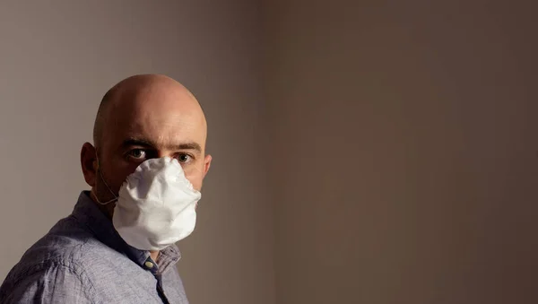 scared caucasian man wearing protective standard FFP2 antiviral face mask