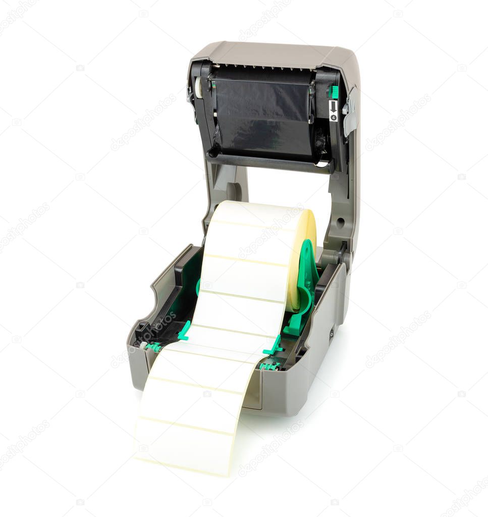 Printer with ribbon and white label roll isolated on white background with shadow reflection. White reel of labels and printer. Studio picture showing thermal transfer print setup. Close-up shot.
