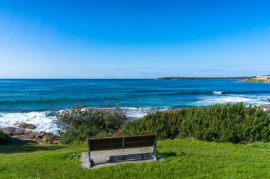 Ocean landscape with one bench on a cliff