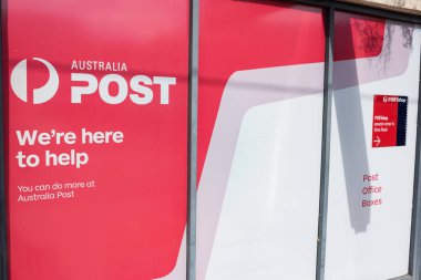 Australia Post post office boxes and shop advertisement sign