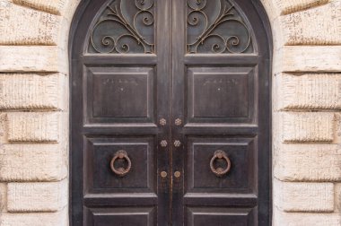 Closed old style wooden door with cast iron lattice decoration, 