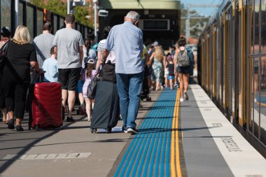 Crowd of people alighting from the train in Sydney clipart