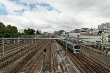 Train approaching Ueno station in Tokyo. Railway track infrastru
