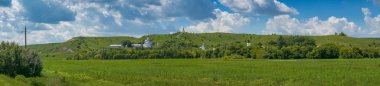 Wide panorama of monastery complex with white churches with gold