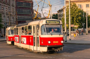 Red tramway public transport with driver and passengers