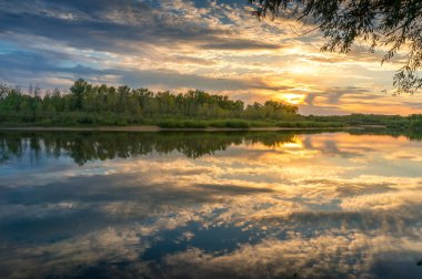 Beautiful sunset nature landscape with calm river and picturesqu