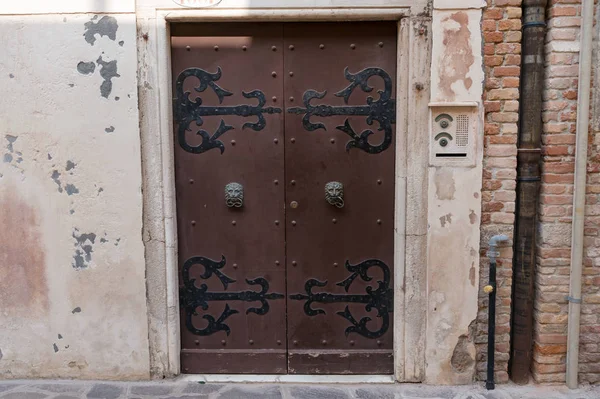 Old vintage door with metal hinges and door handles