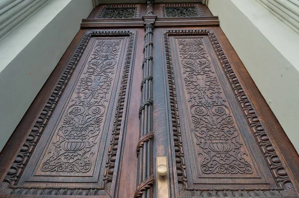 View up on closed wooden carved door — ストック写真